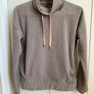 Gray Lulu Lemon pullover with side pockets and tie funnel neck.